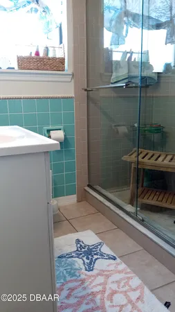 a bathroom with a shower and a sink