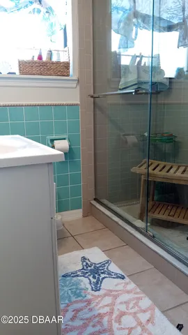 a bathroom with a shower and a sink