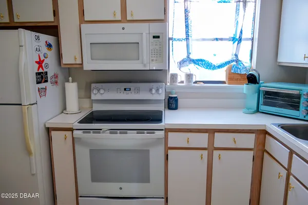 a kitchen with appliances cabinets and a window