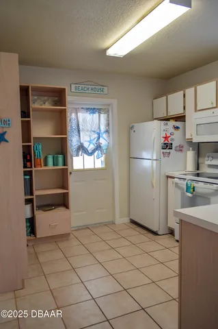 a kitchen with a refrigerator and cabinets