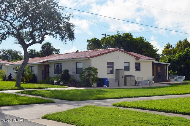 a front view of a house with garden
