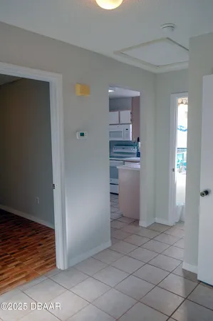 a kitchen with white cabinets and refrigerator