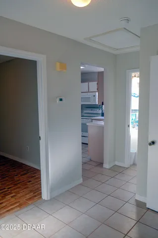 a kitchen with white cabinets and refrigerator
