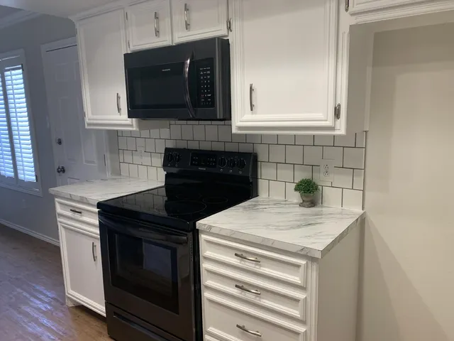 a kitchen with a sink stove and microwave