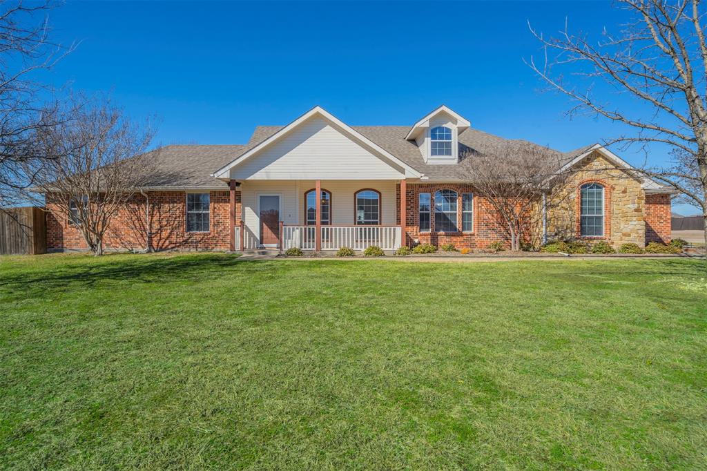 View of front of home and yard including the covered front porch - perfect for rocking chairs and morning coffee!