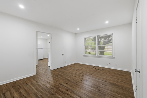 1608 Burt Street Bryan, TX 77802 - Photo 15 of 16 an empty room with wooden floor and windows