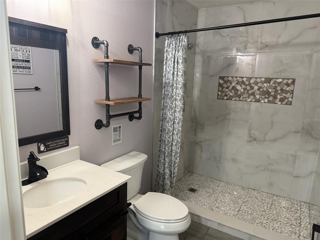 18312 Hollister Road Orlando, FL 32820 - Photo 1 of 10 a bathroom with a sink a toilet and shower
