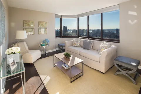 a bed room with a bed a mirror and a table