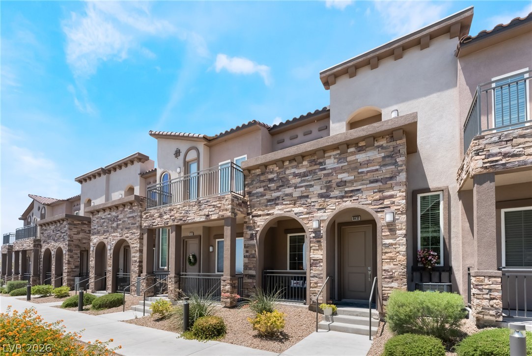 Showcasing a row of sophisticated townhomes with attractive stone and stucco facades.