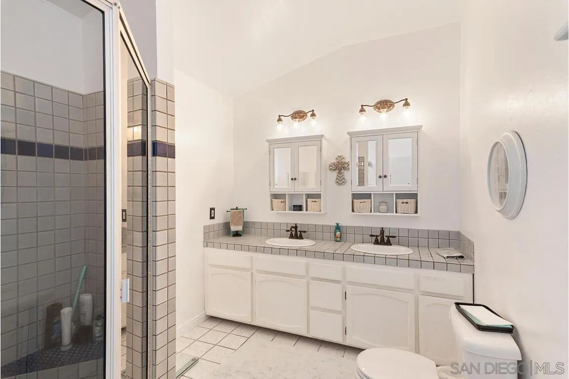 2877 Polk Road Alpine, CA 91901 - Photo 19 of 40 a bathroom with a double vanity sink mirror and toilet