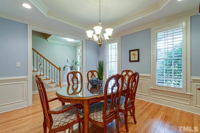 a kitchen with a refrigerator and a stove top oven