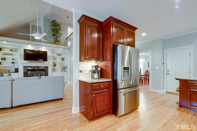 a kitchen with stainless steel appliances granite countertop wooden cabinets a stove top oven a sink and dishwasher