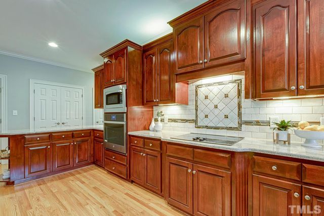 a kitchen with stainless steel appliances granite countertop a sink and cabinets