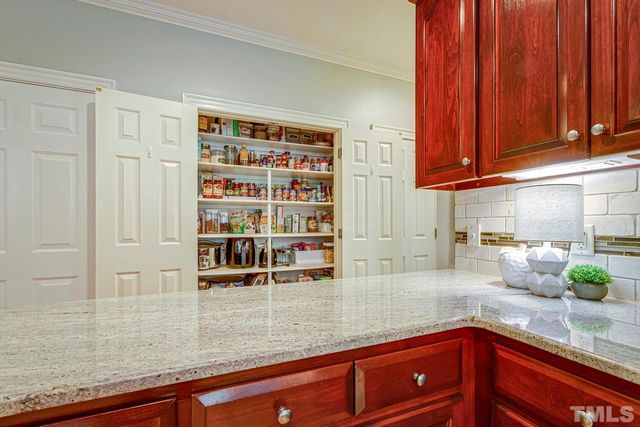 a kitchen with stainless steel appliances granite countertop a refrigerator a sink dishwasher a stove and white countertops with wooden floor