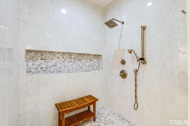 a bathroom with a tub sink and mirror