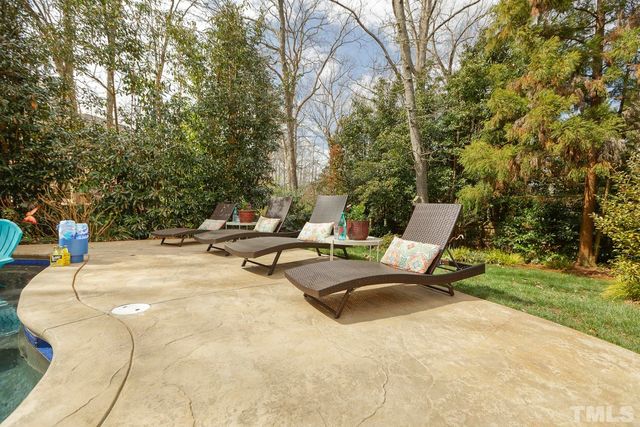 a swimming pool with outdoor seating and yard