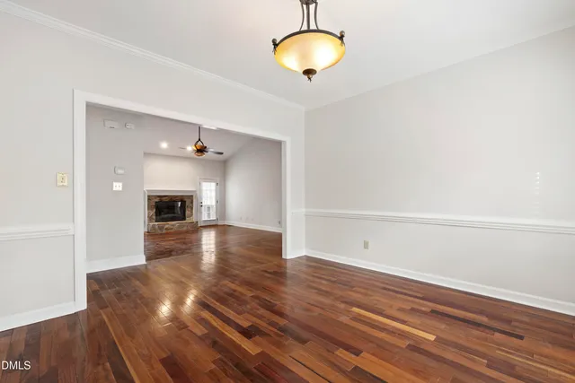 a view of empty room with wooden floor