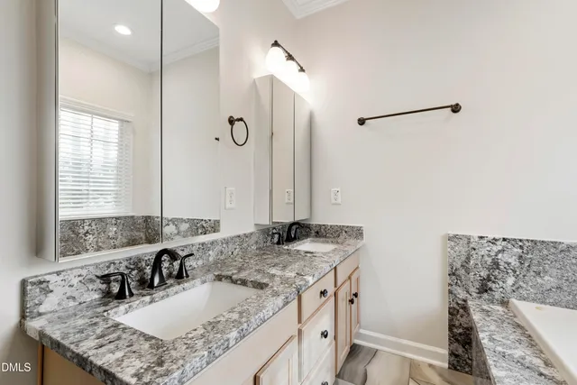 a bathroom with a granite countertop sink a mirror and a shower