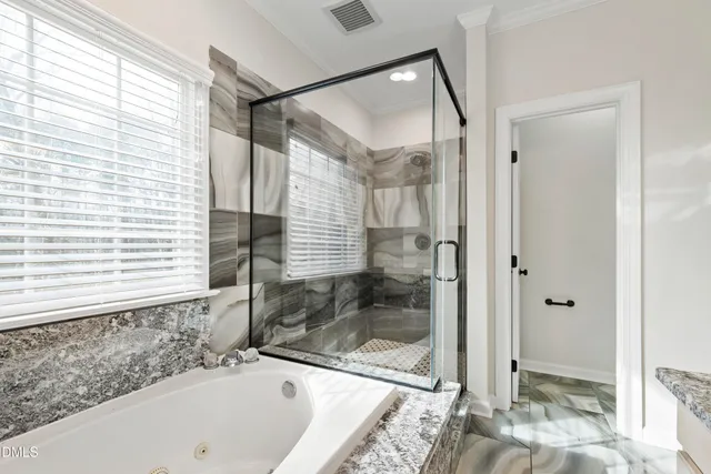a bathroom with a tub and shower