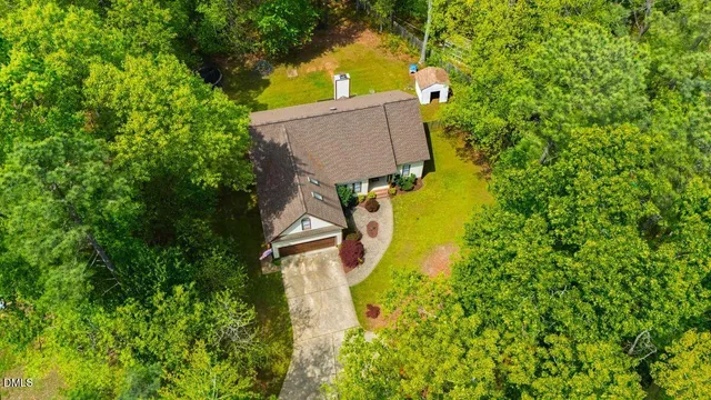 a aerial view of a house with swimming pool and garden