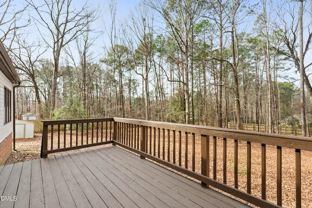 a view of balcony with wooden floor and fence
