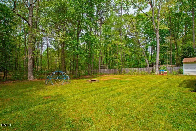 a view of a house with swimming pool and a yard