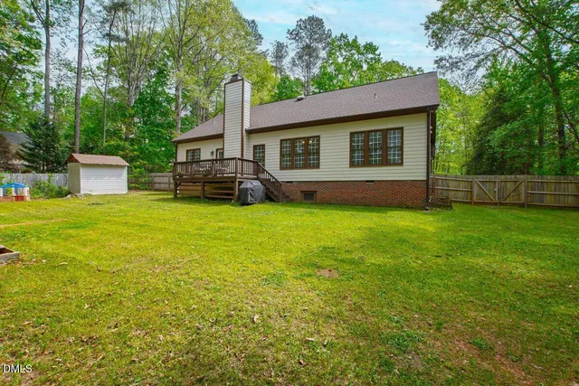 a front view of a house with yard and green space