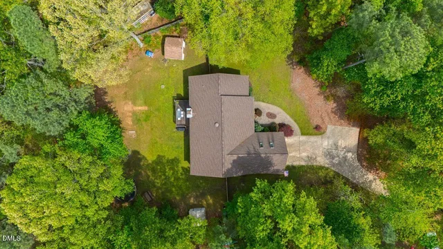 an aerial view of a house with a yard and swimming pool
