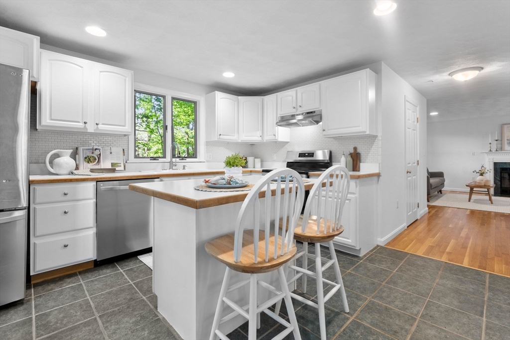 40 Cornell Road Beverly, MA 01915 - Photo 12 of 31 a kitchen with stainless steel appliances kitchen island granite countertop a sink a stove a refrigerator and cabinets