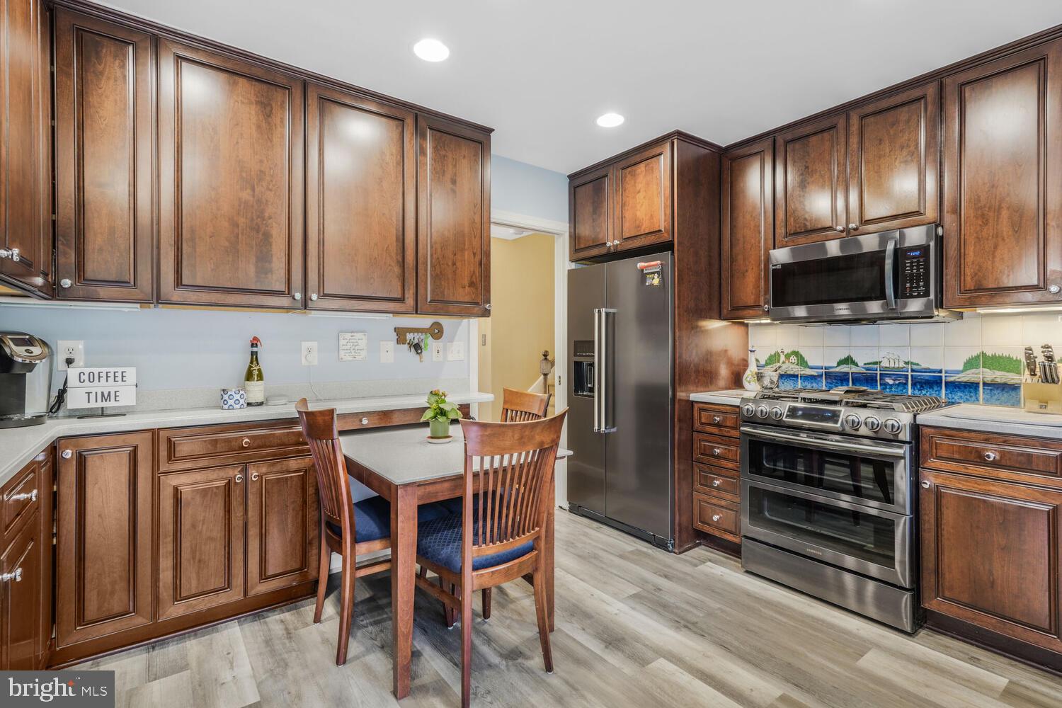 412 Underhill Place Alexandria, VA 22305 - Photo 13 of 45 a kitchen with stainless steel appliances wooden cabinets granite counter tops and a stove top oven
