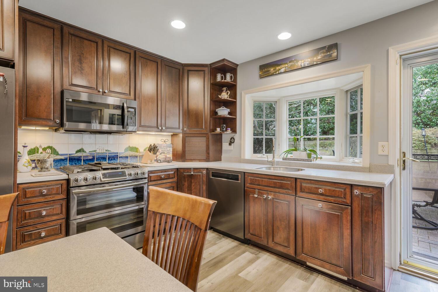 412 Underhill Place Alexandria, VA 22305 - Photo 14 of 45 a kitchen with stainless steel appliances granite countertop wooden cabinets a stove top oven a sink and dishwasher