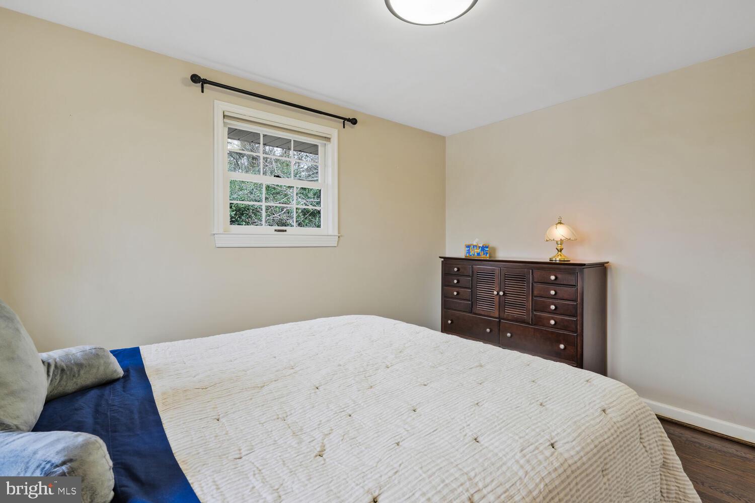 412 Underhill Place Alexandria, VA 22305 - Photo 21 of 45 a bedroom with a bed and dresser with mirror