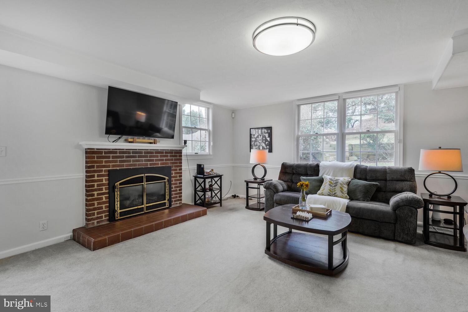412 Underhill Place Alexandria, VA 22305 - Photo 26 of 45 a living room with furniture a flat screen tv and a fireplace