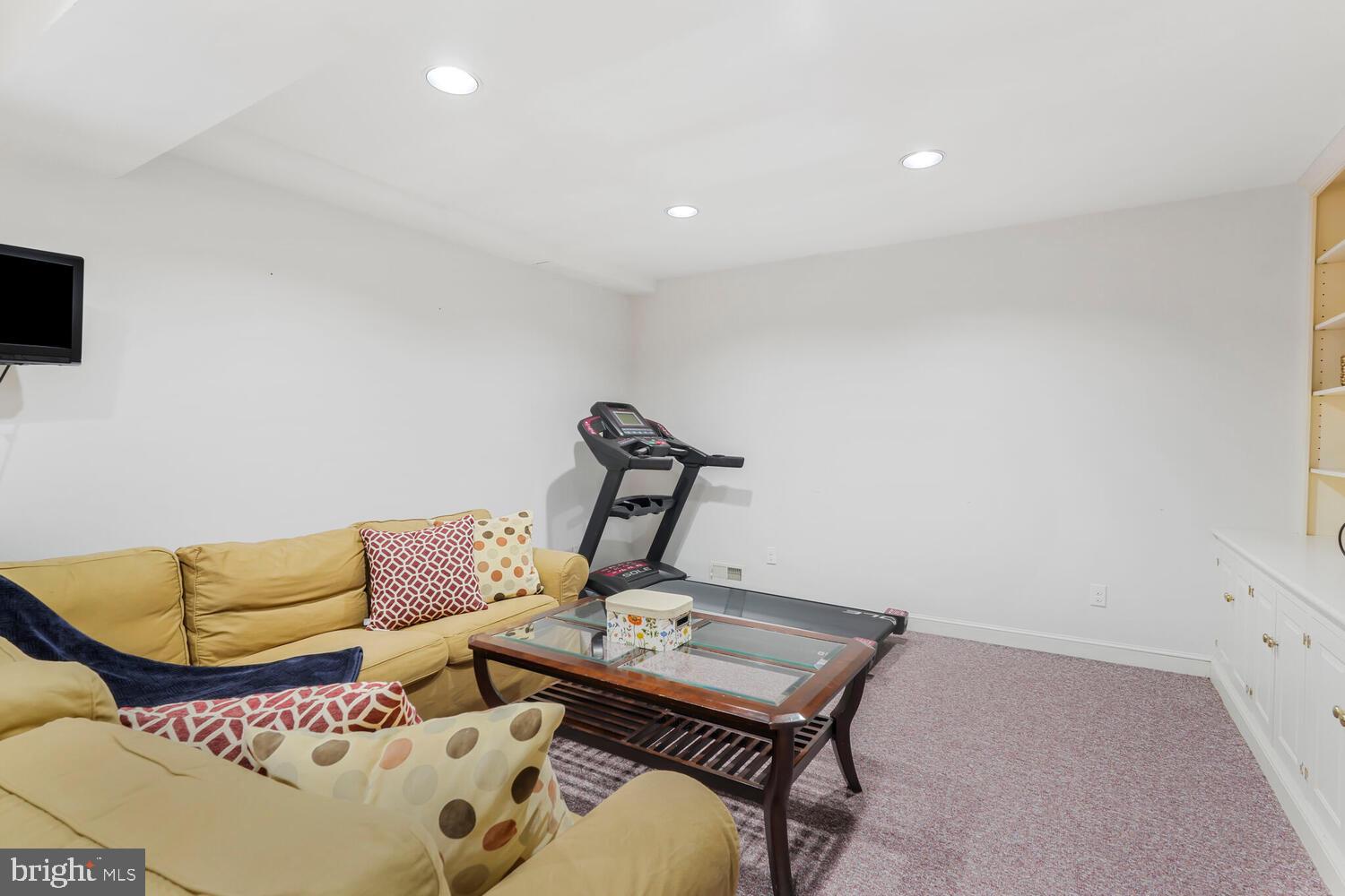412 Underhill Place Alexandria, VA 22305 - Photo 30 of 45 a living room with furniture and a flat screen tv