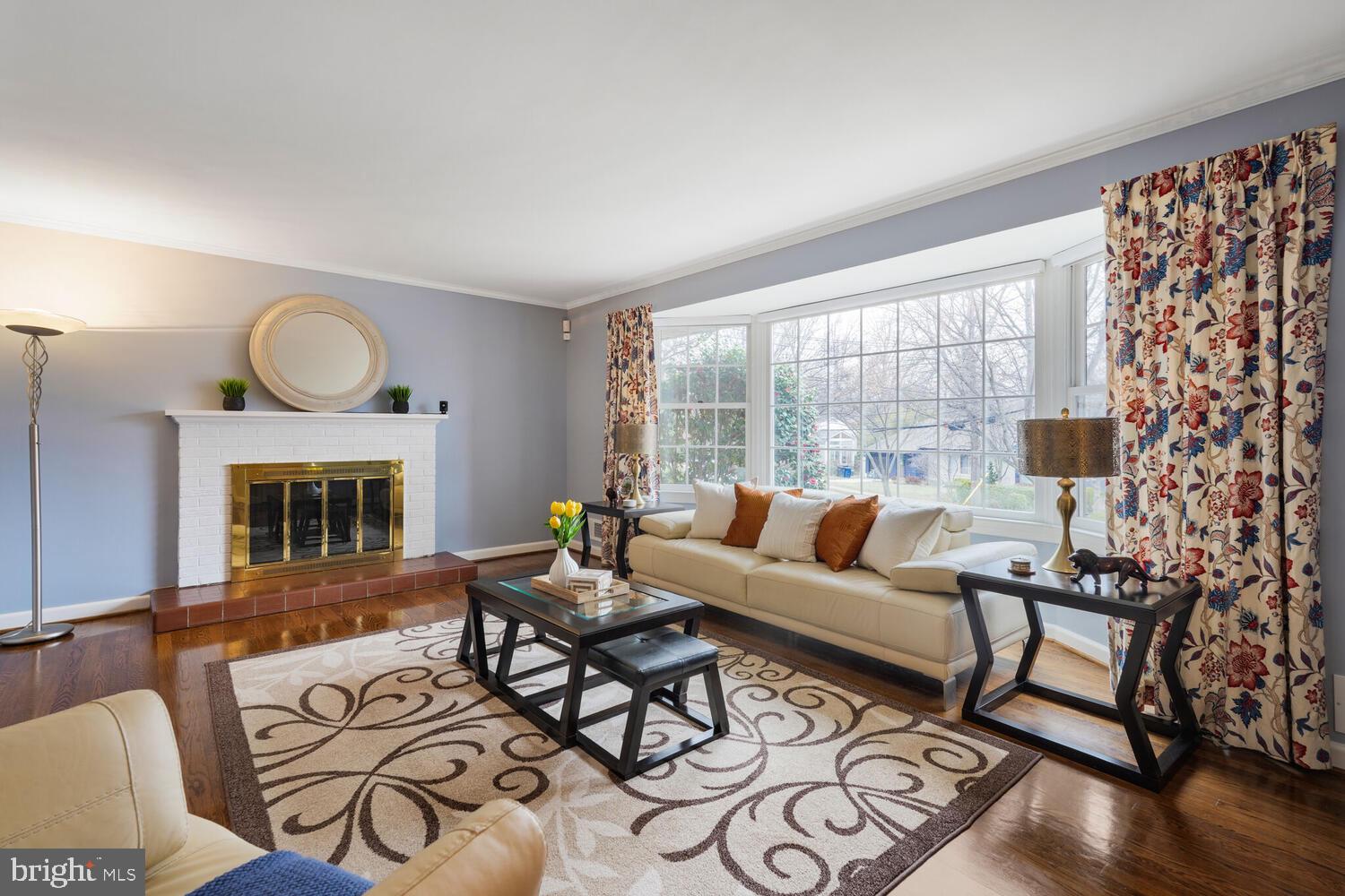412 Underhill Place Alexandria, VA 22305 - Photo 4 of 45 a living room with furniture a fireplace and a floor to ceiling window