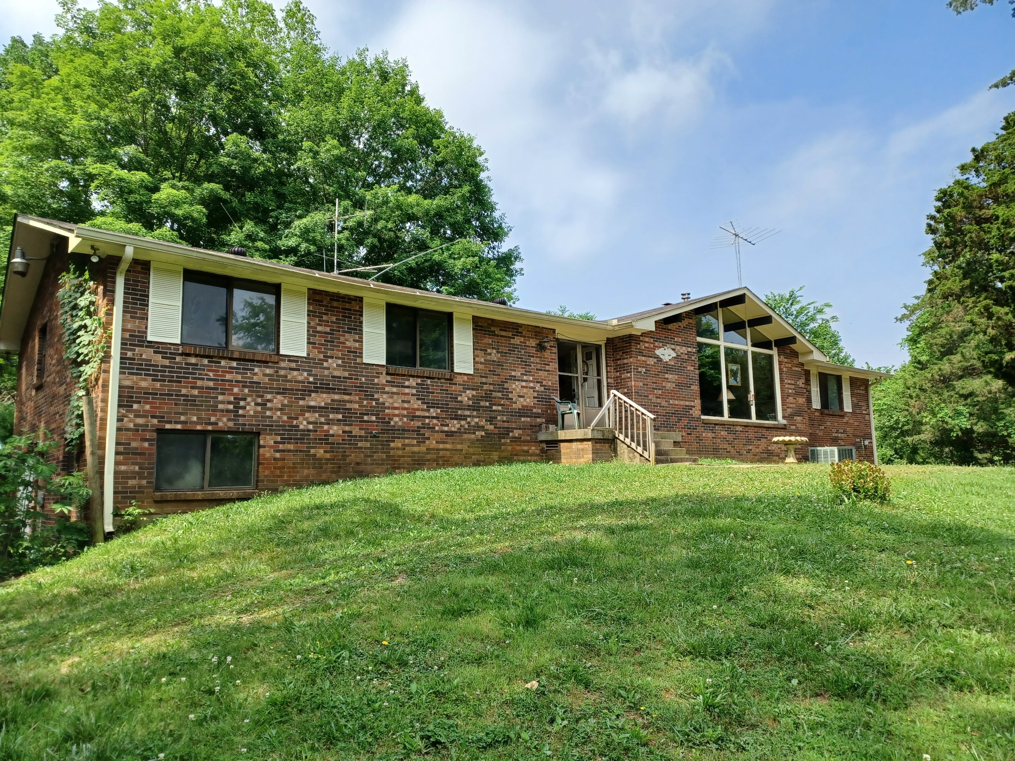 2150 Hogan Road Burns, TN 37029 - Photo 1 of 58 a front view of house with yard and green space