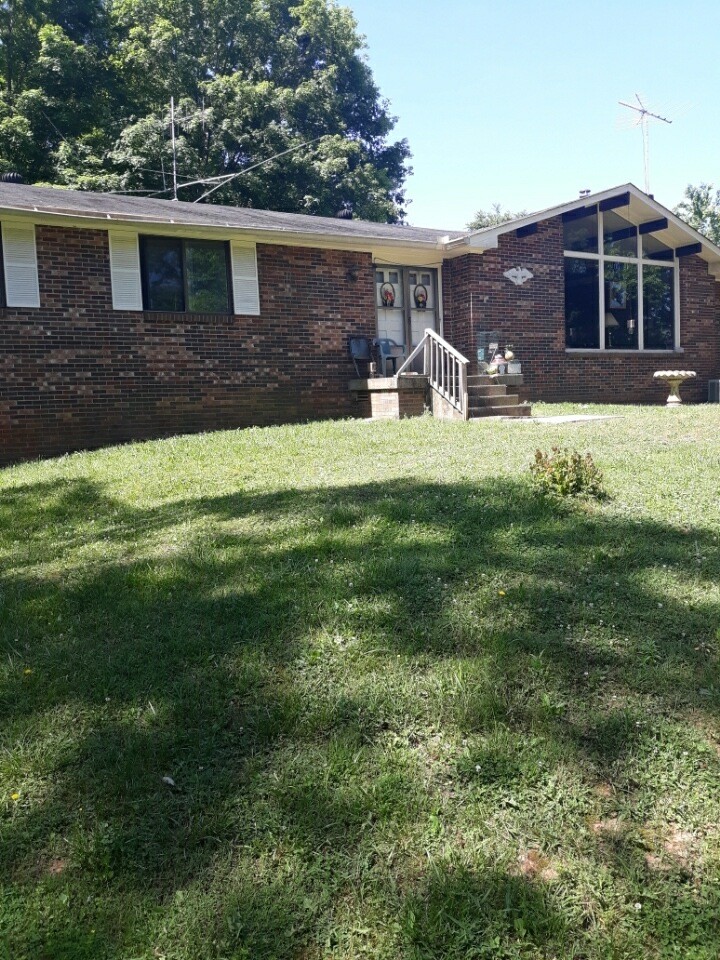 2150 Hogan Road Burns, TN 37029 - Photo 2 of 58 a front view of a house with a yard