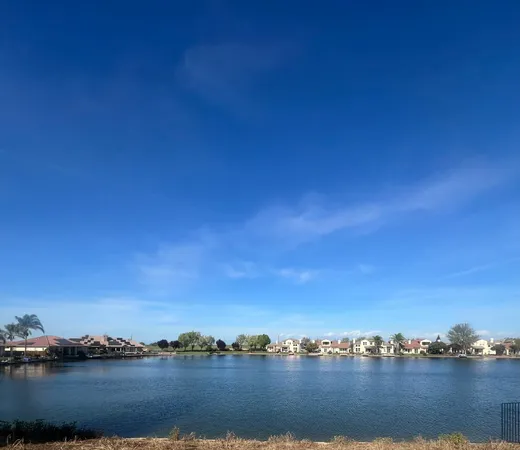 a view of a lake with houses in the background