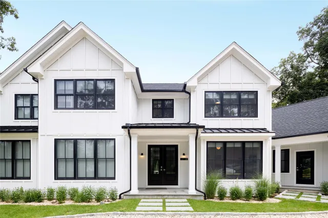 an aerial view of a house with swimming pool a yard and pool