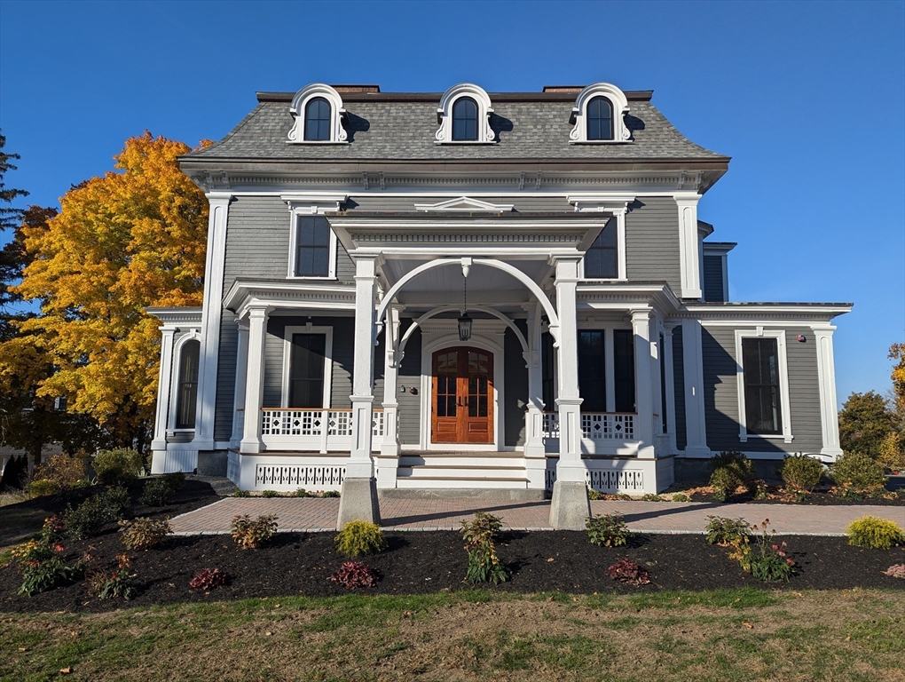 a front view of a house with yard