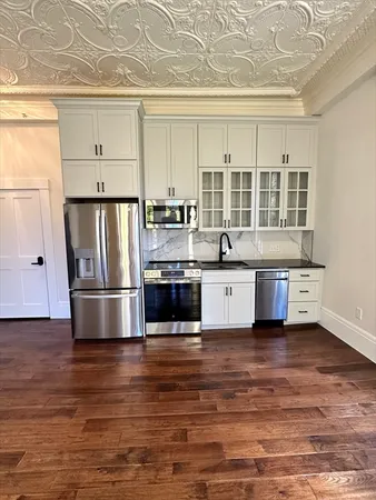 a kitchen with stainless steel appliances a refrigerator sink and cabinets