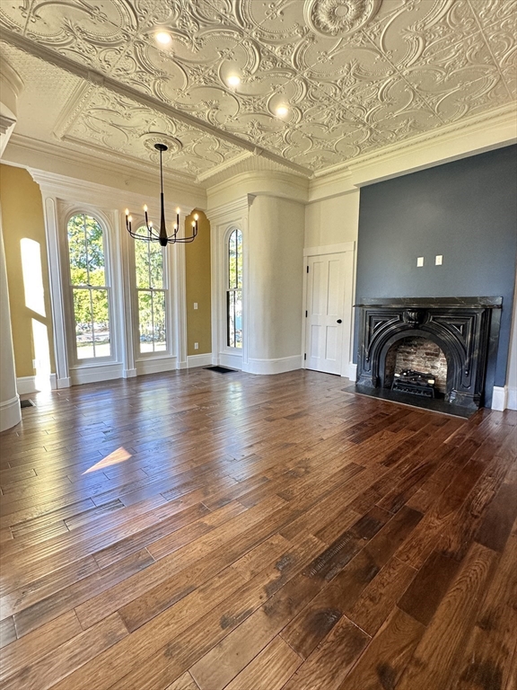 11 Lowell Road, Unit 1A Groton, MA 01450 - Photo 12 of 17 a view of a livingroom with wooden floor and a fireplace