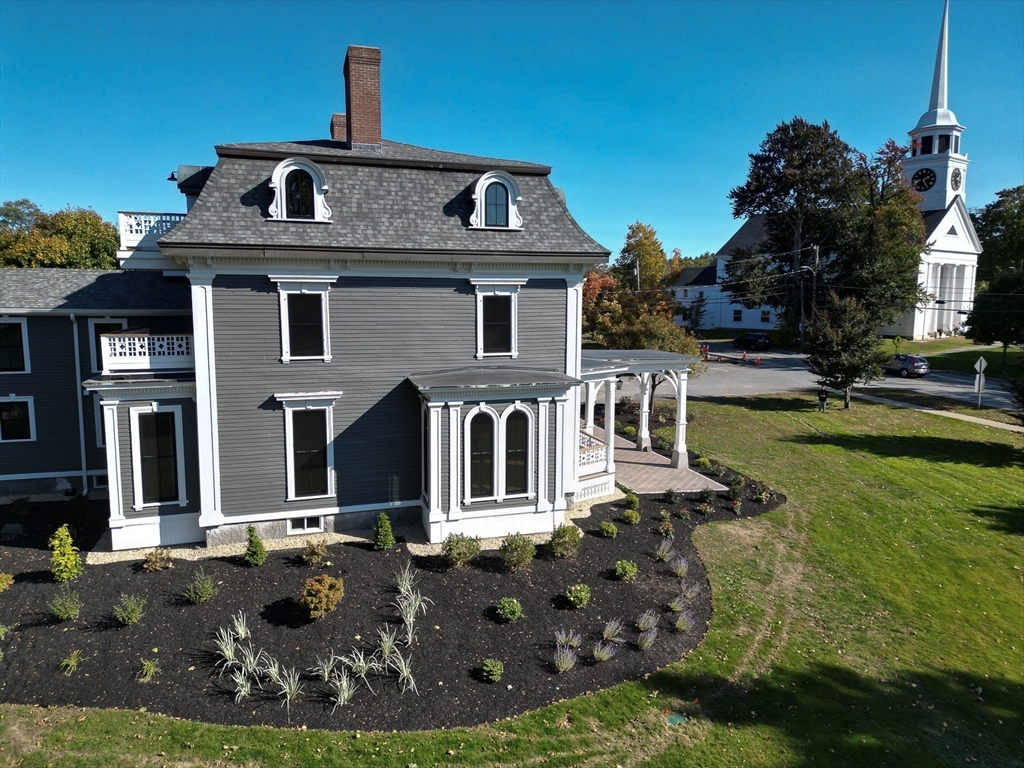 11 Lowell Road, Unit 1A Groton, MA 01450 - Photo 2 of 17 front view of house with a yard
