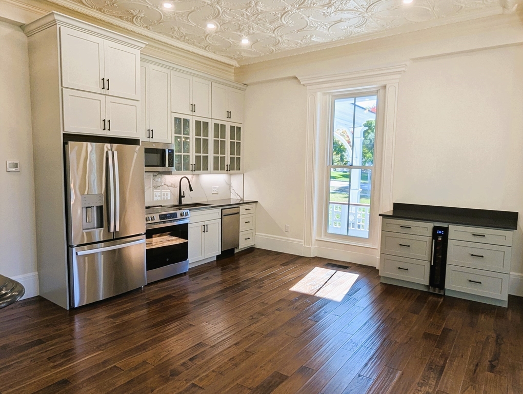 11 Lowell Road, Unit 1A Groton, MA 01450 - Photo 10 of 17 a kitchen with stainless steel appliances a stove and a refrigerator