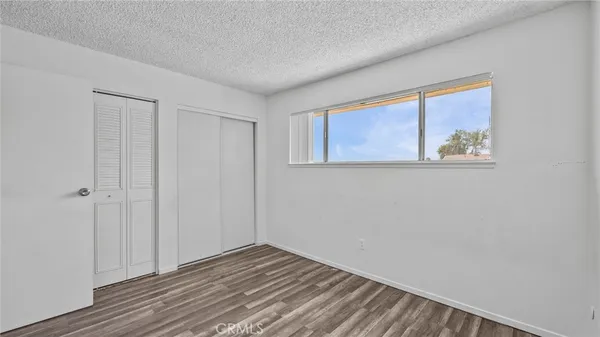 a view of a room with wooden floor and closet