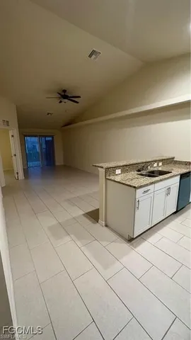 a kitchen with stainless steel appliances granite countertop a sink and cabinets