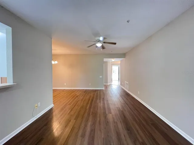 a kitchen with a sink a refrigerator and cabinets