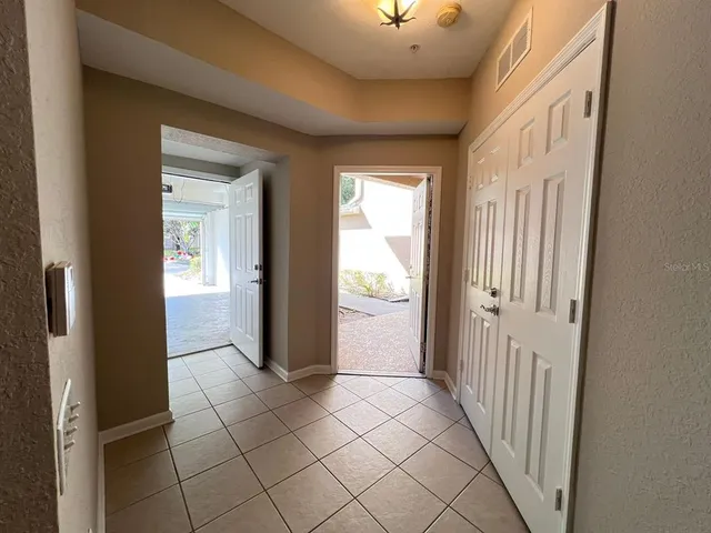 a view of a hallway with wooden shelves