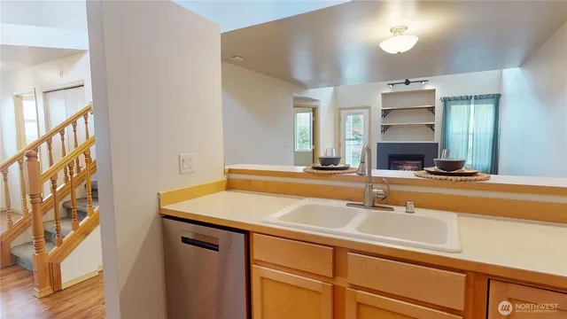a view of empty room with wooden floor and fireplace
