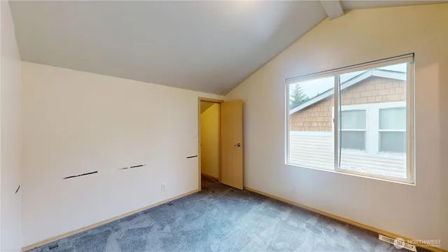 a view of an empty room and a window